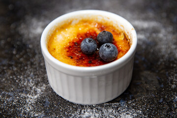 Traditional creme brulee on rustic surface and selective focus
