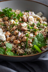 Healthy Salad made from Quinoa, Cucumber, Herbs, Pistachios, Chickpeas and Feta with lemon juice and olive oil. So called Jennifer Aniston Salad, fresh, crunchy, and packed with plant-based protein