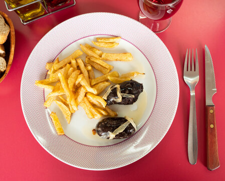 Main Course For Dinner Is Fried Grilled Fatty Blood Sausage Black Pudding With Bow And Slices Of French Fries Complemented By Bread 