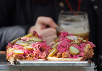Refreshments at the farmers street food market stall, bread with pulled meat, red cabbage and pickles
