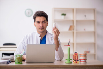 Young male dentist working in the clinic