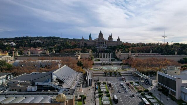Aerial long view of Avinguda de la Reina Maria Cristina at its junction with Montjuic Palace in background. This iconic square is located at foot of Montjuic major landmark in Barcelona. 4K video