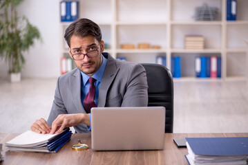 Young male employee working in the office