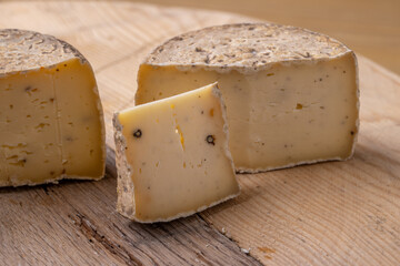 close up of maturated selection of cheese on old wood