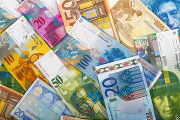 Swiss Francs and EU Euro Bills of various banknotes values.