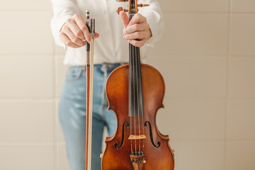 Female Hands Holding Beautiful ViolinFiddle, an Orchestra or Bluegrass Instrument