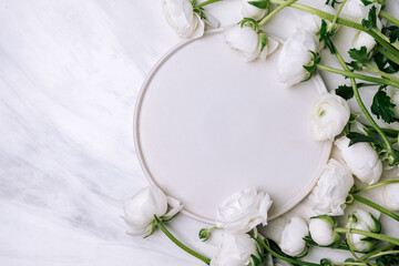 Spring romantic table setting with white plate and  white flowers ranunculus. Easter food background. Flat lay.
