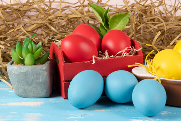eggs in wooden box with hay on rustic background or surface, easter or holiday concept