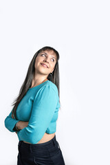 Portrait of a charming young woman standing with arms crossed over white background