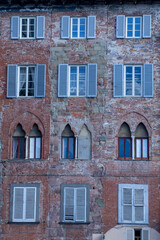Fototapeta na wymiar Exterior of typical Italian buildings. Lucca, Tuscany, Italy..