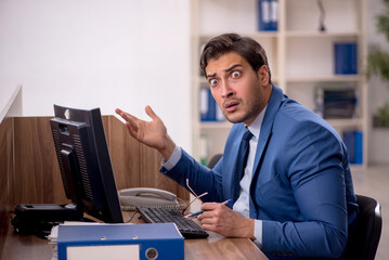 Young male employee working in the office