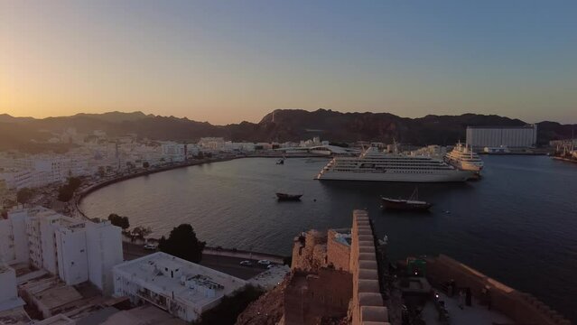 Muscat, Oman: Panoramic view of the Mutrah old town and corniche by the Indian ocean in Muscat, Oman capital city at sunset. 