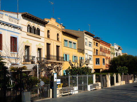Scenic view of Spanish city of Vilassar de Mar overlooking typical buildings along street on sunny day, Catalonia