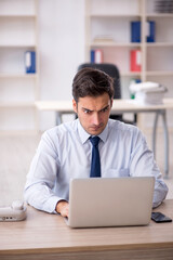 Young male employee working in the office