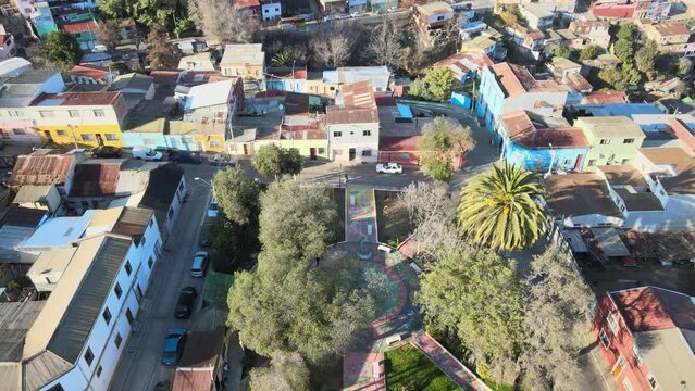 Overflight of the Santa Margarita square, its trees and pigeons, from Cerro Larra&iacute;n to the south, housing complexes of Cerro Polanco and Cerro O'Higgins, sunny summer morning