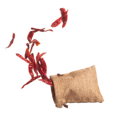 Dried Red hot Chilli fall down in Sack Bag, dried Red Chilli float explode, abstract cloud fly. Dried Red hot Chillis splash throwing in Air. White background Isolated high speed shutter, freeze