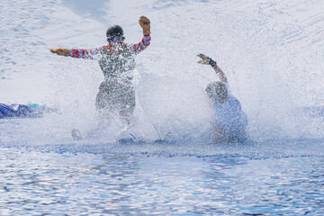 Naklejka premium People are enjoying Pond skim at the end of ski season
