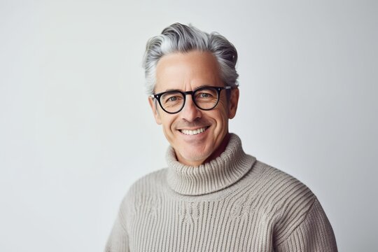 Mature man with salt and pepper hair in black-framed glasses and white turtleneck sweater on a white background. Generative AI
