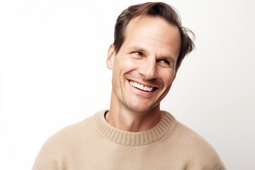 Portrait of a handsome young man smiling on a white background.