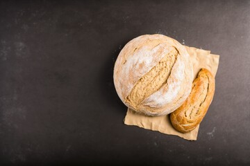two freshly baked loaves, freshly baked bread on a brown stone table