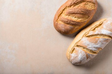  two freshly baked loaves, freshly baked bread on a stone table