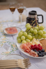 Picnic table with grapes and red berries