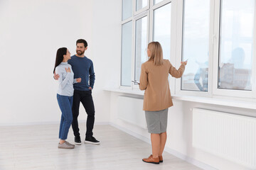 Real estate agent showing new apartment to couple