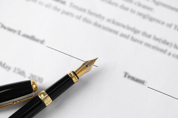 Fountain pen on document with place for signature, top view. Notary contract