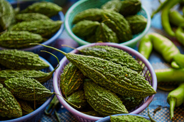 Close-up view of bitter gourd in basket for sale at market