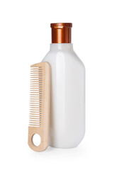 Bottle of shampoo and wooden comb on white background