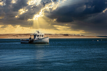 Stormy skies over a fishing boat off the coast of Chatham, Cape Cod, Massachusetts