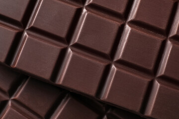 Many delicious dark chocolate bars as background, top view