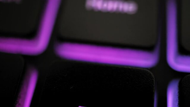 Closeup of illuminated keyboard, pirple illuminated END and HOME keyboard. Gaming keyboard concept