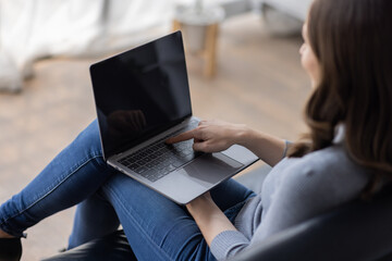 Fototapeta premium Portrait of young happy canadian female freelancer checking email news online sitting on sofa,for friends, studying, blogging, resting and chatting online. High quality photo