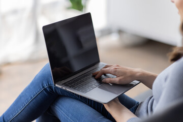 Portrait of  young happy canadian female freelancer checking email news online sitting on sofa,for friends, studying, blogging, resting and chatting online. High quality photo