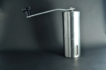 Silver manual coffee grinder with black background