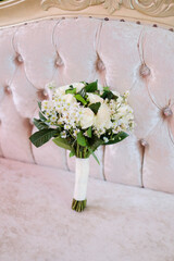 A bouquet of white flowers sits on a table.