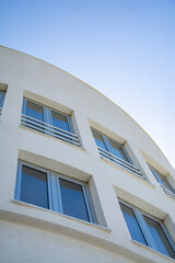 Modern apartment building exterior, Detail of a modern building with blue sky in the background.