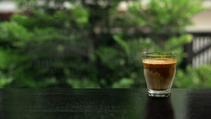 Dirty Coffee - A glass of espresso shot mixed with cold fresh milk in coffee shop cafe and restaurant