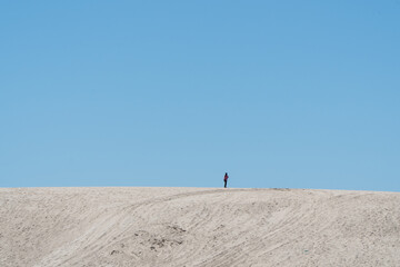 lonely person not visible walking among the desert dunes