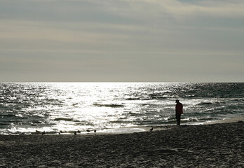 Silhouetted Tourist on the Beach