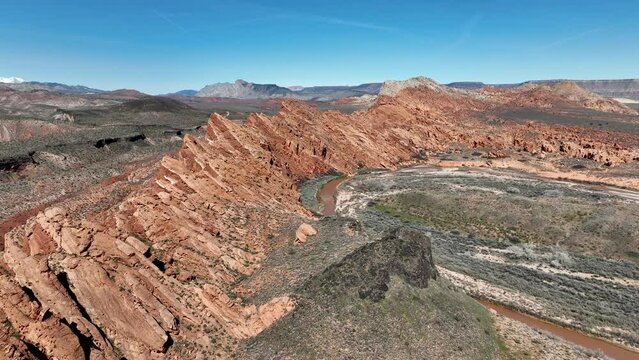 Aerial southern Utah Virgin River gorge valley 2 4K. Southwestern desert Utah near St George. Red stone black volcanic mountain landscape. Wilderness area. Geological erosion, landscape wind, weather.