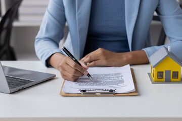 Real estate broker agent presenting and consult to customer to decision making sign insurance form agreement, buy and sell home model, concerning mortgage loan offer for and house insurance	