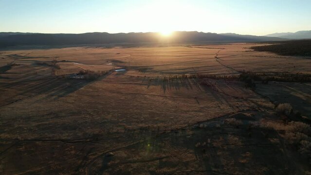 Sunrise fly over the plains of Buena Vista, Colorado, near the Rocky Mountain National Park. Aerial 4K drone video