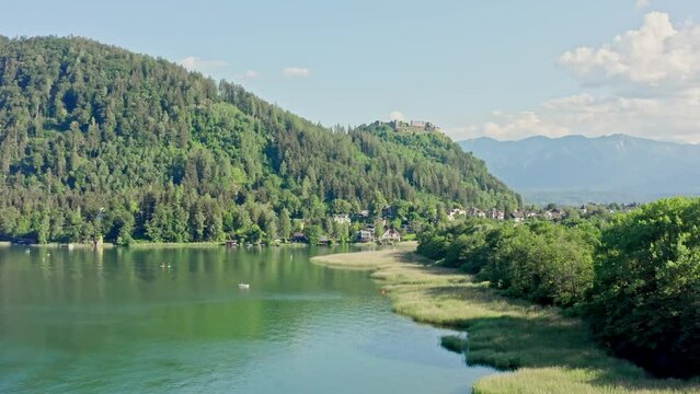 Lake Ossiach is a stunning alpine lake located in the state of Carinthia, Austria, surrounded by the majestic Nock Mountains and offering a range of recreational activities. Aerial view