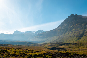 View of surrounding mountains on a sunny day at Kirkjufell, Iceland
