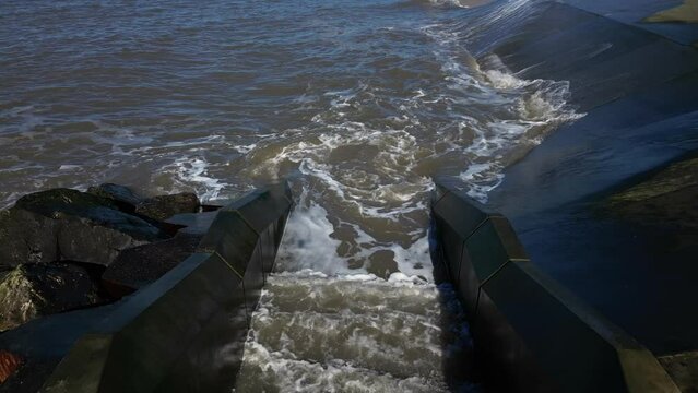 Slow motion seawater sloshing down steps at Fleetwood sea defences