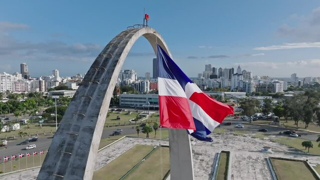 Flag of the Dominican republic waves in the wind, slow motion aerial