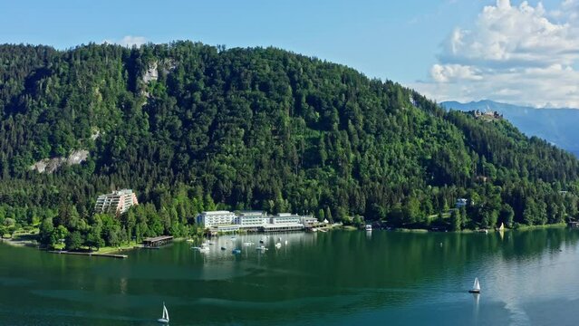 Lake Ossiach is a stunning alpine lake located in the state of Carinthia, Austria, surrounded by the majestic Nock Mountains and offering a range of recreational activities. Aerial view
