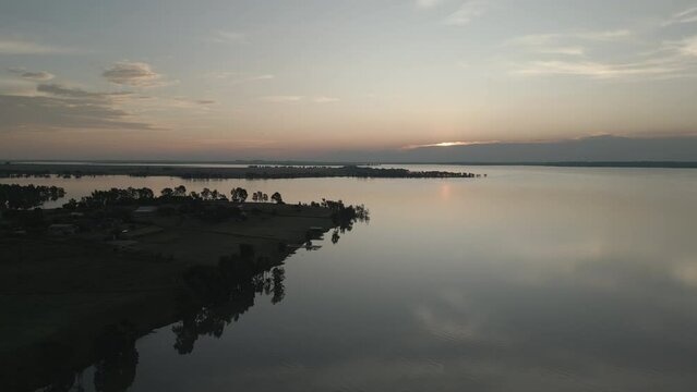 Aerial shot of a sunset over the Vaal dam in Gauteng, South Africa - showing the dam embankment and a beautiful summer evening sky.